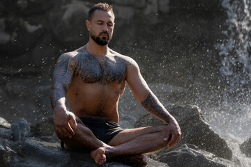 Meditation man with fit body. Muscular male meditation in lotus pose. Guy practicing yoga. Meditation in nature. Mental balance. Abdominal flexible body. Belly vacuum exercise. Zen meditation.