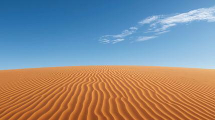 Fototapeta premium Expansive Sand Dunes under Clear Blue Sky with Subtle White Clouds and Textured Patterns on Golden Sands in an Arid Desert Landscape