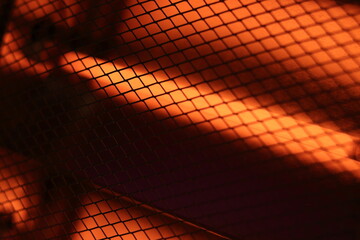 Abstract Bright Grid Pattern with Warm Orange Light Effect. Domestic electric heater