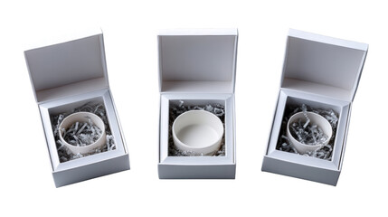 Three elegantly packaged ceramic bowls in white boxes with decorative filling, showcasing modern design
