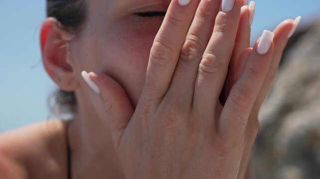 hands face cover Woman hiding face with hands outdoors under blue sky