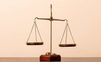 Gilded scales with two hanging bowls on a yellow background