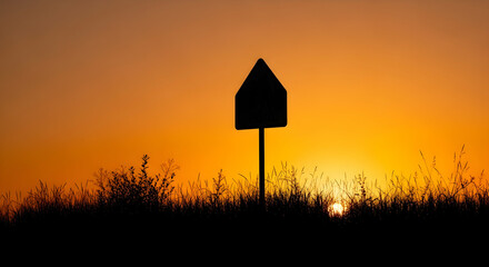Signpost Silhouette Against Fiery Sunset Sky In Golden Hour Landscape Concept
