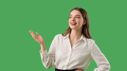 Professional woman in white blouse gesturing while speaking in front of a green screen