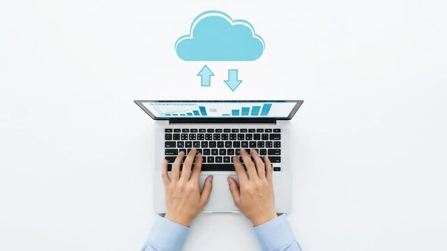 A persons hands type on a laptop displaying charts, with a cloud icon symbolizing data transfer
