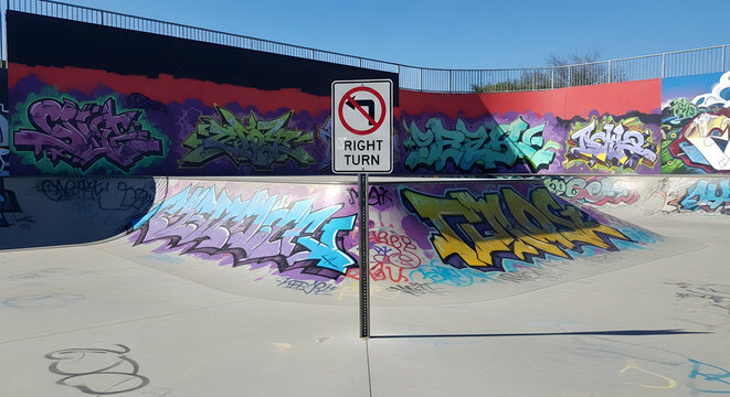 Urban Skatepark Scene With Graffiti Art and a Right Turn Prohibition Sign