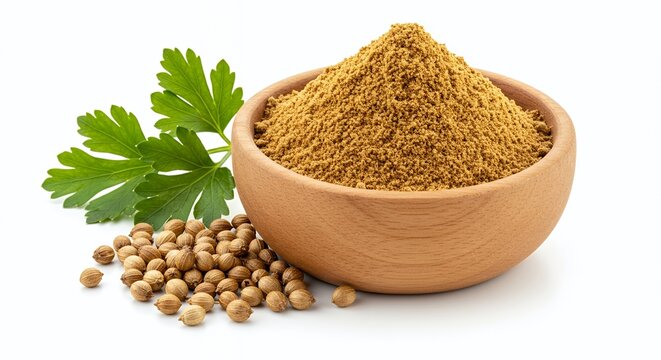 Coriander powder in bowl with coriander seeds and leaf on white