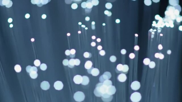 Here's a concise sentence to describe the image
Abstract blue background with glowing bokeh circles and glistening water drops evokes a festive winter holiday design  4k video