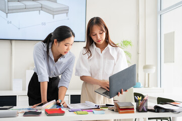 Architects, interior designers, creative project plans, loose furniture designs and selects  materials with material samples on the table.