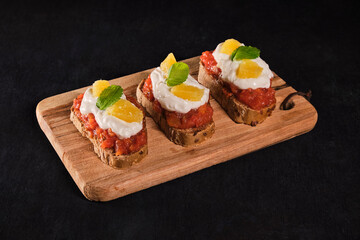Assorted bruschetta with various toppings.Appetizing bruschetta.Variety of small sandwiches.Mix...