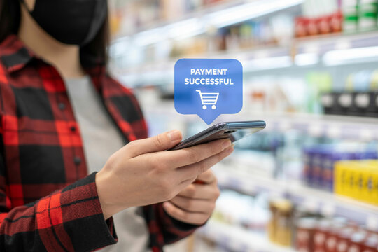 Person using smartphone for successful mobile payment in grocery store shopping during pandemic