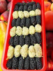 A basket of colorful mulberries at a local market.