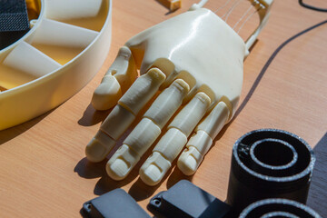 Plastic hand printed on 3D printer. Human arm prosthesis created on a 3D printer from molten...