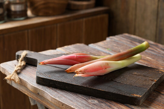 Close-Up of Fresh Bunga Kantan or Torch Ginger Flower on Rustic Surface as Aromatic Ingredient in Malaysian Cuisine
