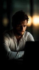 Fototapeta premium Pensive businessman in a moody office at dusk