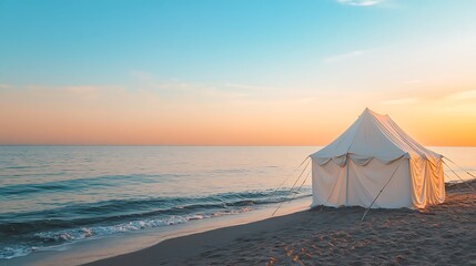 Minimalist white tent on a sandy beach at sunset waves gently lapping nearby