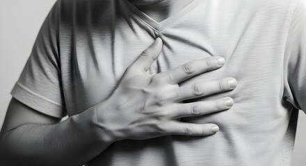 A person clutching their chest, possibly experiencing discomfort or pain