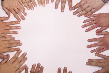 children of different nationalities put their hands together on a white background in the shape of a heart