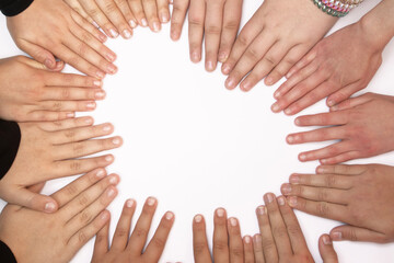 children of different nationalities put their hands together on a white background in the shape of a heart