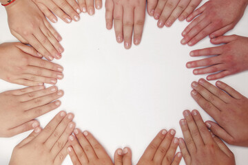 children of different nationalities put their hands together on a white background in the shape of a heart