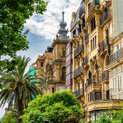 Facades of high-end buildings next to the Urumea River in the tourist city of San Sebastian, Basque...