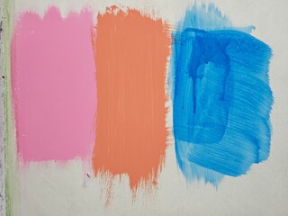 A wall covered in three colors of paint