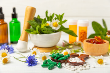 Alternative medicine herbal capsule organic drug on wooden background.Assortment of herbal and...