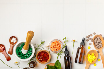 Alternative medicine herbal capsule organic drug on wooden background.Assortment of herbal and...
