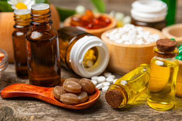 Alternative medicine herbal capsule organic drug on wooden background.Assortment of herbal and...