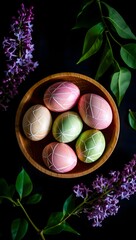 Beautiful easter eggs in wooden bowl with lilac flowers for spring holiday celebration
