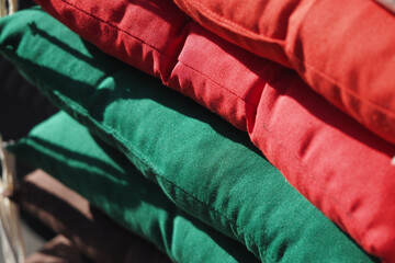 Colorful stack of outdoor cushions in bright shades