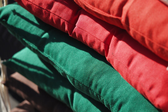 Colorful stack of outdoor cushions in bright shades - Powered by Adobe