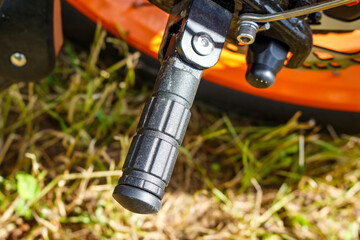 Folding passenger footrest on an electric bike