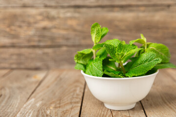 Mint. Fresh organic mint leaves on wooden background. Mint leaves. Peppermint. Close-up. Space for text. Copy space.