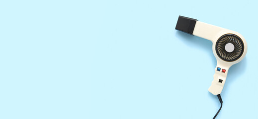 Hair dryer on light blue background