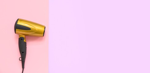 Modern hair dryer on color background with space for text