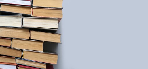 Many books on grey background with space for text, top view