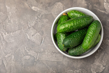 Cucumber on wooden background. Slice of cucumber on background. Fresh organic green cucumbers gherkin. Vegan. Salad ingredient. Farm vegetables. Cut vegetables with knife. Space for text. Copy space