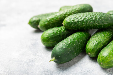 Cucumber on wooden background. Slice of cucumber on background. Fresh organic green cucumbers gherkin. Vegan. Salad ingredient. Farm vegetables. Cut vegetables with knife. Space for text. Copy space