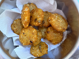 A bowl of fried food with a napkin underneath it