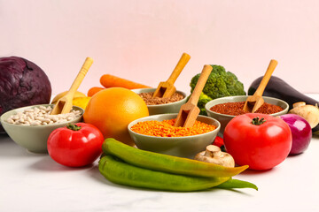 Different fresh vegetables and cereals on white background