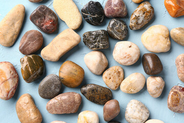 Many pebble stones on blue background