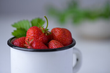 Cup filled with fresh strawberries. Seasonal summer berries, healthy dessert or snack.