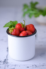 Cup filled with fresh strawberries. Seasonal summer berries, healthy dessert or snack.
