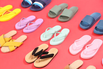 Many pairs of flip-flops on red background