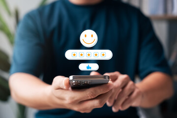 Customer satisfaction review concept showing person using smartphone with five-star rating, smiley face icon, thumbs up, positive feedback, digital service evaluation, and user experience rating.