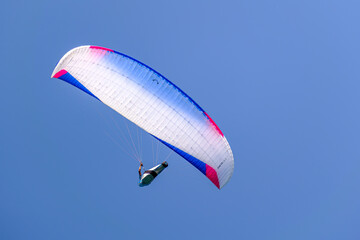Paraglider Against Bright Blue Sky