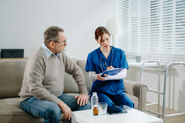 Senior man consulting nurse at home, discussing health and recovery with care, compassion, and...