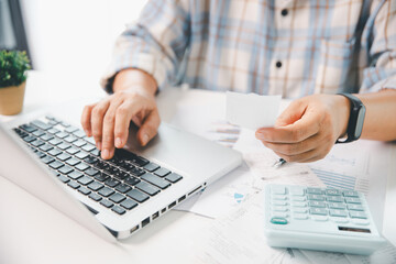 Woman calculating monthly home expenses, taxes, bank account balance and credit card bills payment,...