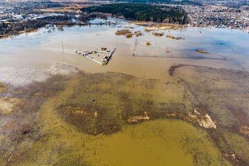 Bird's eye view of flooded floodplain fields in rural area during spring flood
